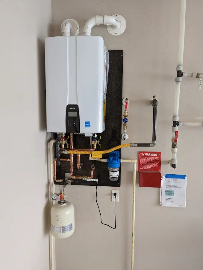 Professional plumber installing copper piping in a Mentone home